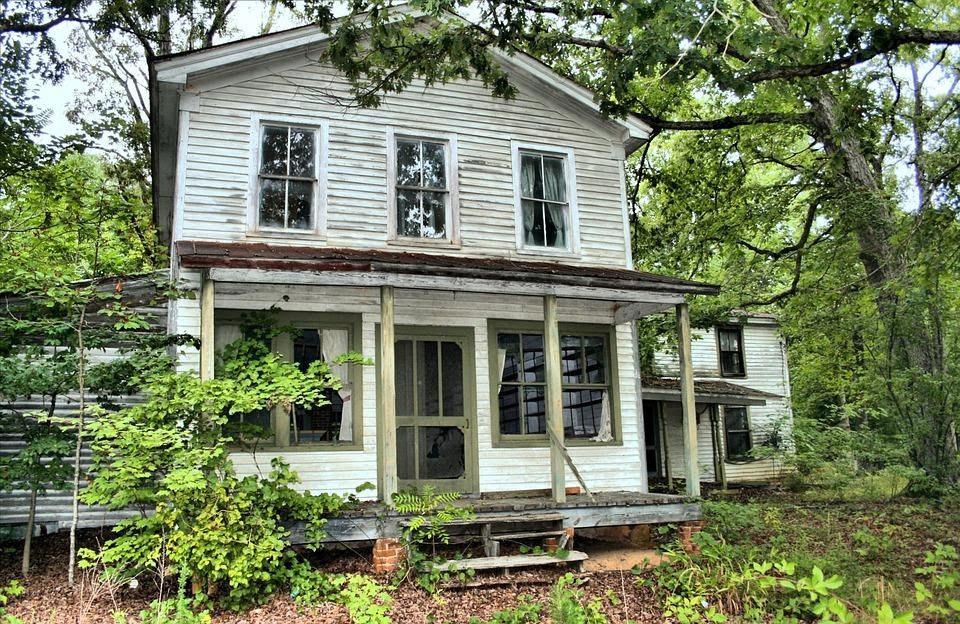 A distressed home in the woods.