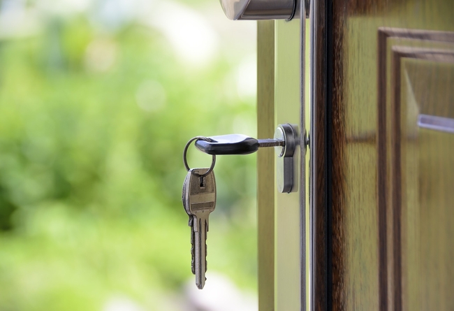 close up of a key inside of a lock with the door open