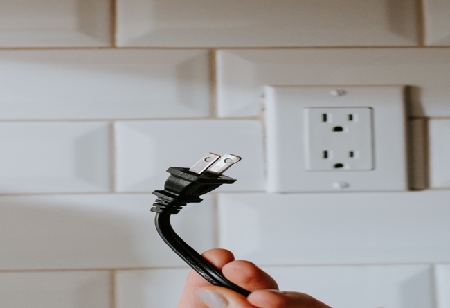 electrical plug in front of a wall socket; can you sell a house with a violation